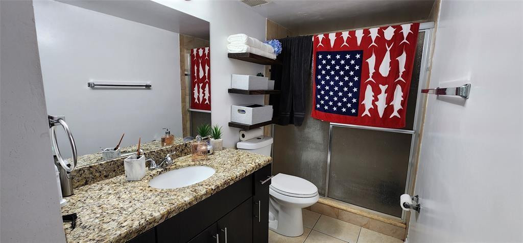 5005 Wiles Road, Unit 106 Coconut Creek, FL 33073 - Photo 19 of 19 a bathroom with a granite countertop sink and a mirror