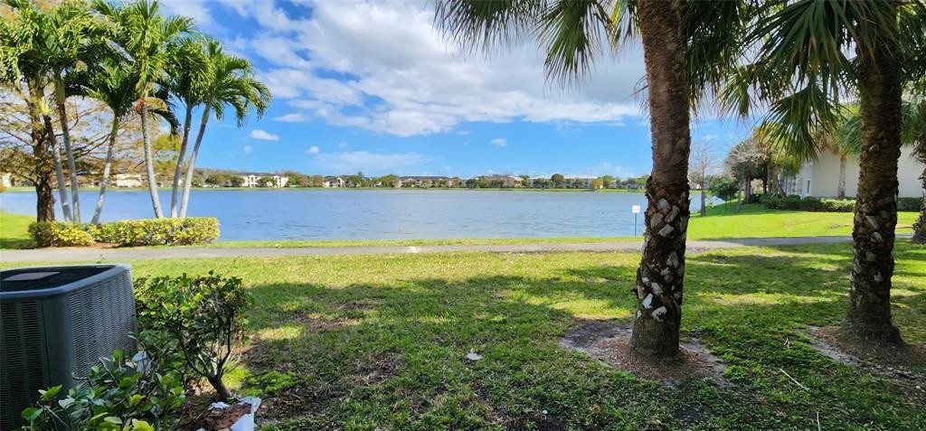 5005 Wiles Road, Unit 106 Coconut Creek, FL 33073 - Photo 4 of 19 a view of a lake with a palm trees
