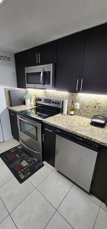 5005 Wiles Road, Unit 106 Coconut Creek, FL 33073 - Photo 8 of 19 a kitchen with stainless steel appliances a sink dishwasher stove and cabinets