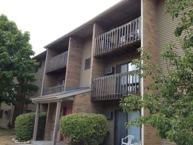 645 South Virginia Road, Unit 224 Crystal Lake, IL 60014 - Photo 1 of 9 front view of a house with a garden
