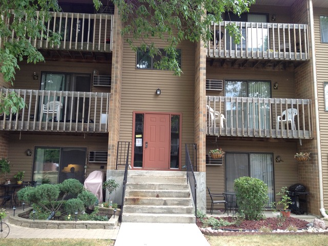 645 South Virginia Road, Unit 224 Crystal Lake, IL 60014 - Photo 2 of 9 a front view of a house with garden