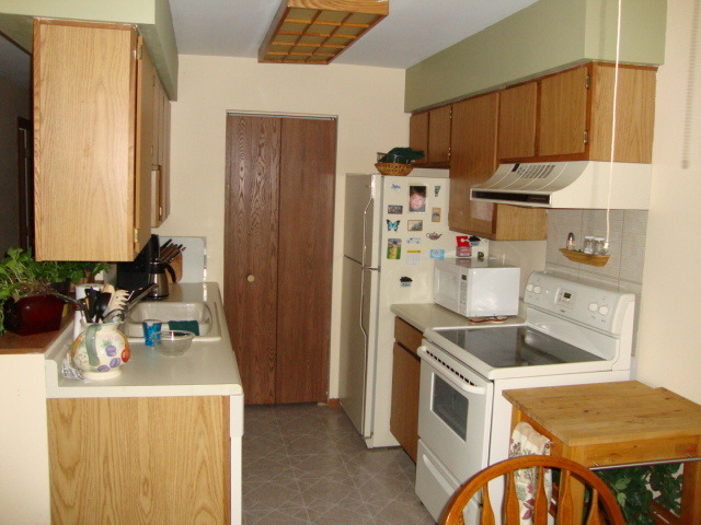 645 South Virginia Road, Unit 224 Crystal Lake, IL 60014 - Photo 5 of 9 a kitchen with a sink a stove and a refrigerator