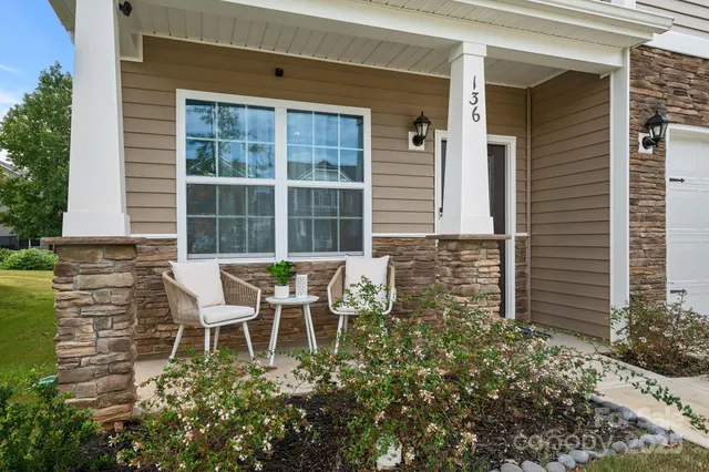 a backyard of a house with table and chairs