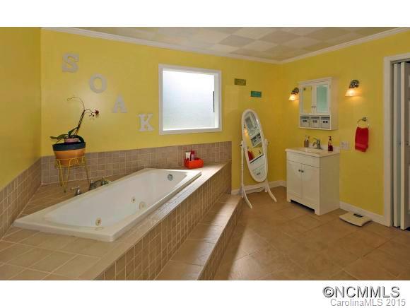 951 Old Clyde Road Clyde, NC 28721 - Photo 14 of 18 a bathroom with a tub sink and mirror