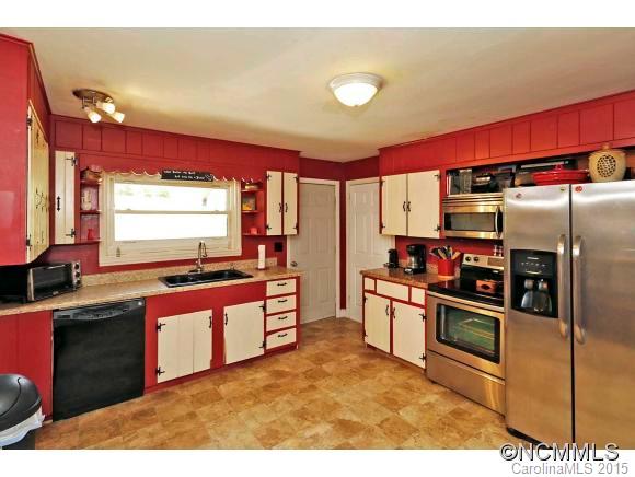951 Old Clyde Road Clyde, NC 28721 - Photo 5 of 18 a kitchen with stainless steel appliances granite countertop a stove a sink and a refrigerator