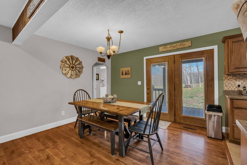 465 Hickory Lane Sparta, TN 38583 - Photo 25 of 46 a view of a dining room with furniture wooden floor and a chandelier