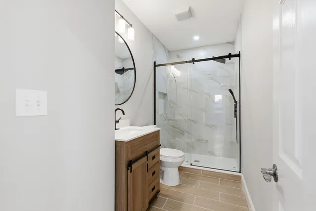 a bathroom with a toilet a sink and shower