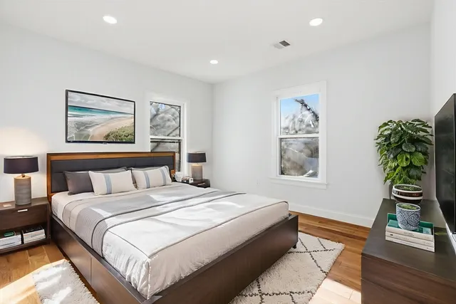 a bedroom with a bed and a painting on the wall