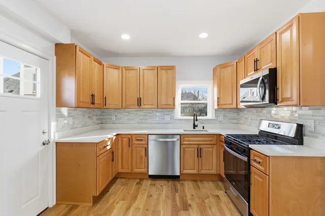 a kitchen with a sink stove and cabinets
