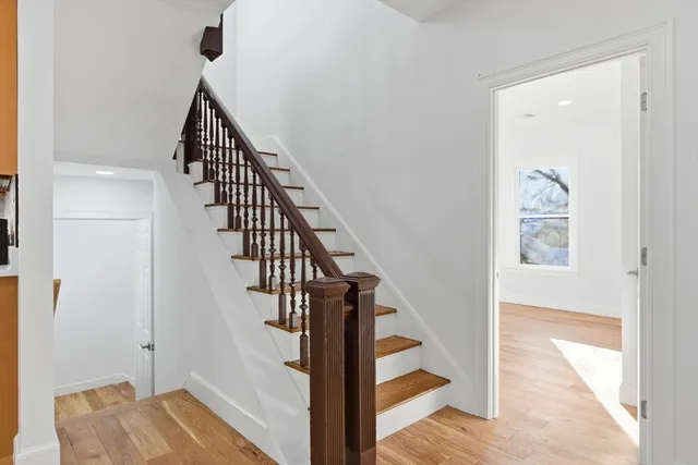 a view of entryway and hall with wooden floor