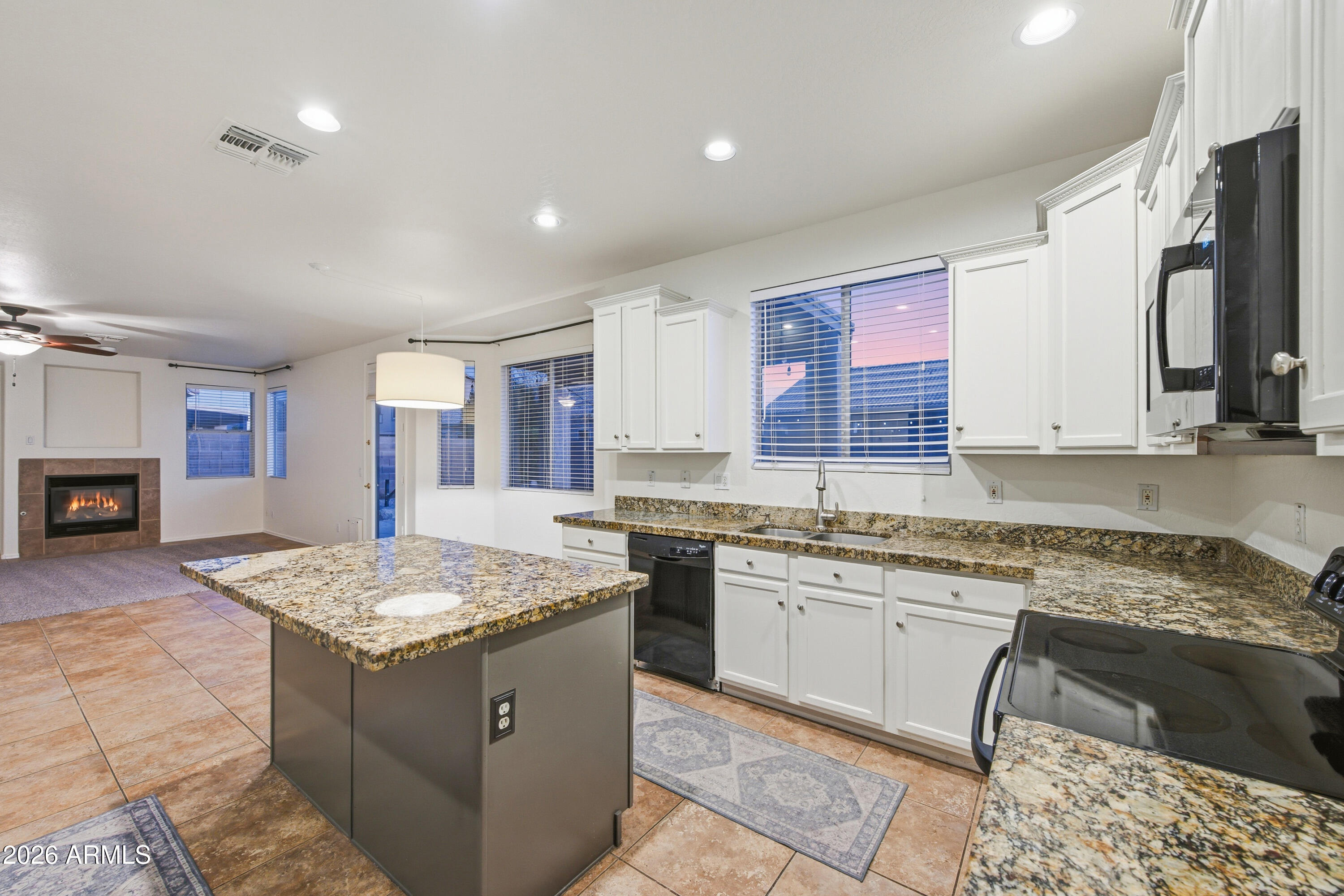 3535 East Derringer Way Gilbert, AZ 85297 - Photo 13 of 37 a kitchen with a stove sink and cabinets