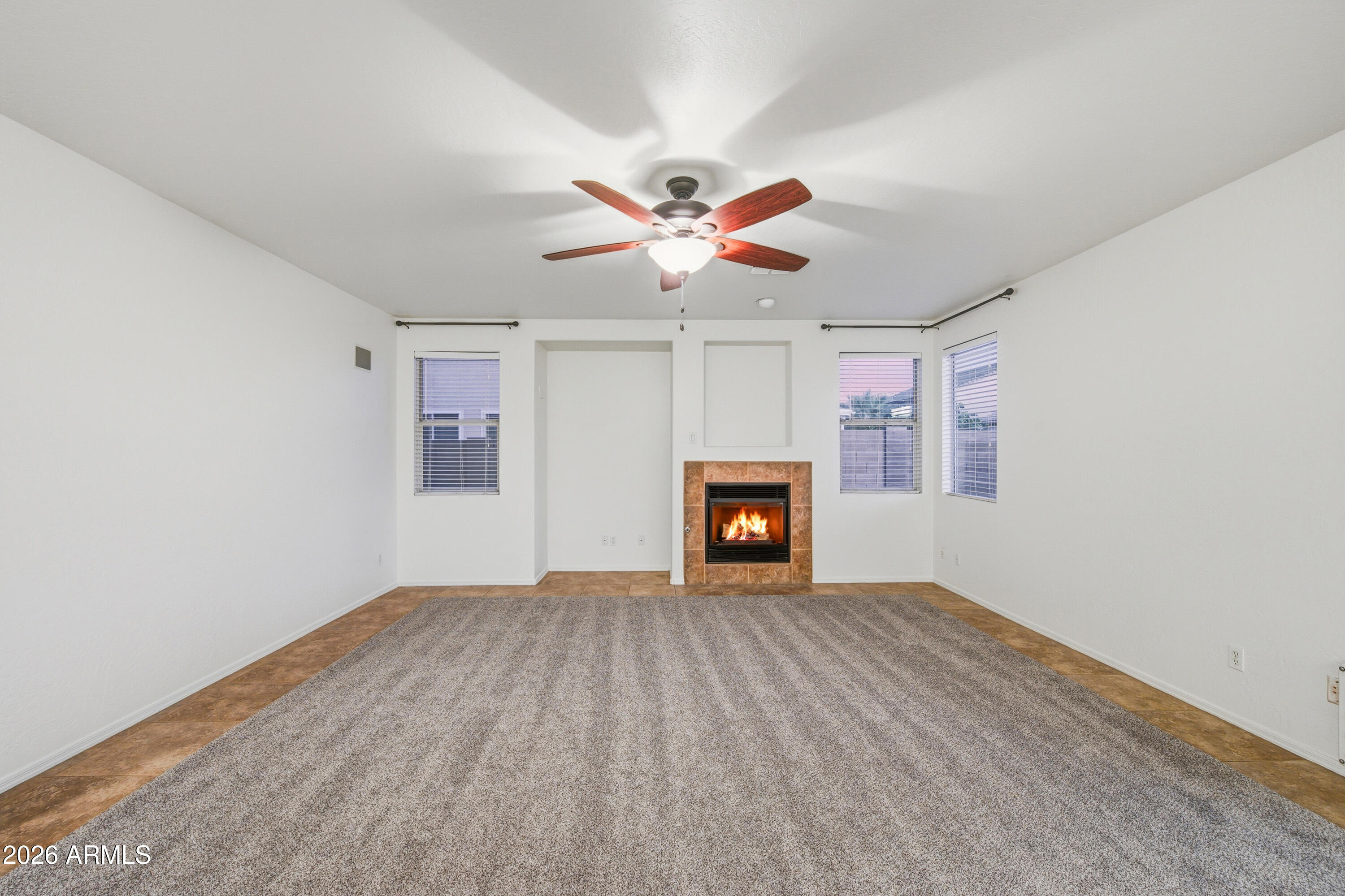 3535 East Derringer Way Gilbert, AZ 85297 - Photo 8 of 37 an empty room with windows and a fireplace