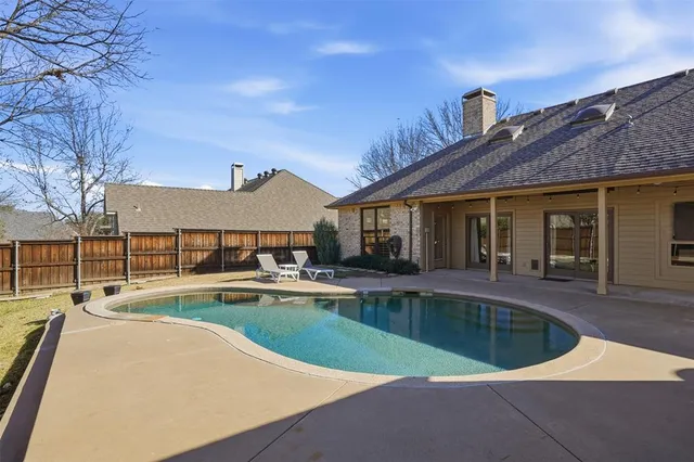a view of a house with swimming pool in front of it