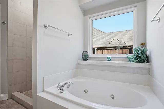 a bathroom with a tub and window
