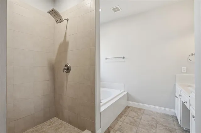 a bathroom with a bathtub and shower