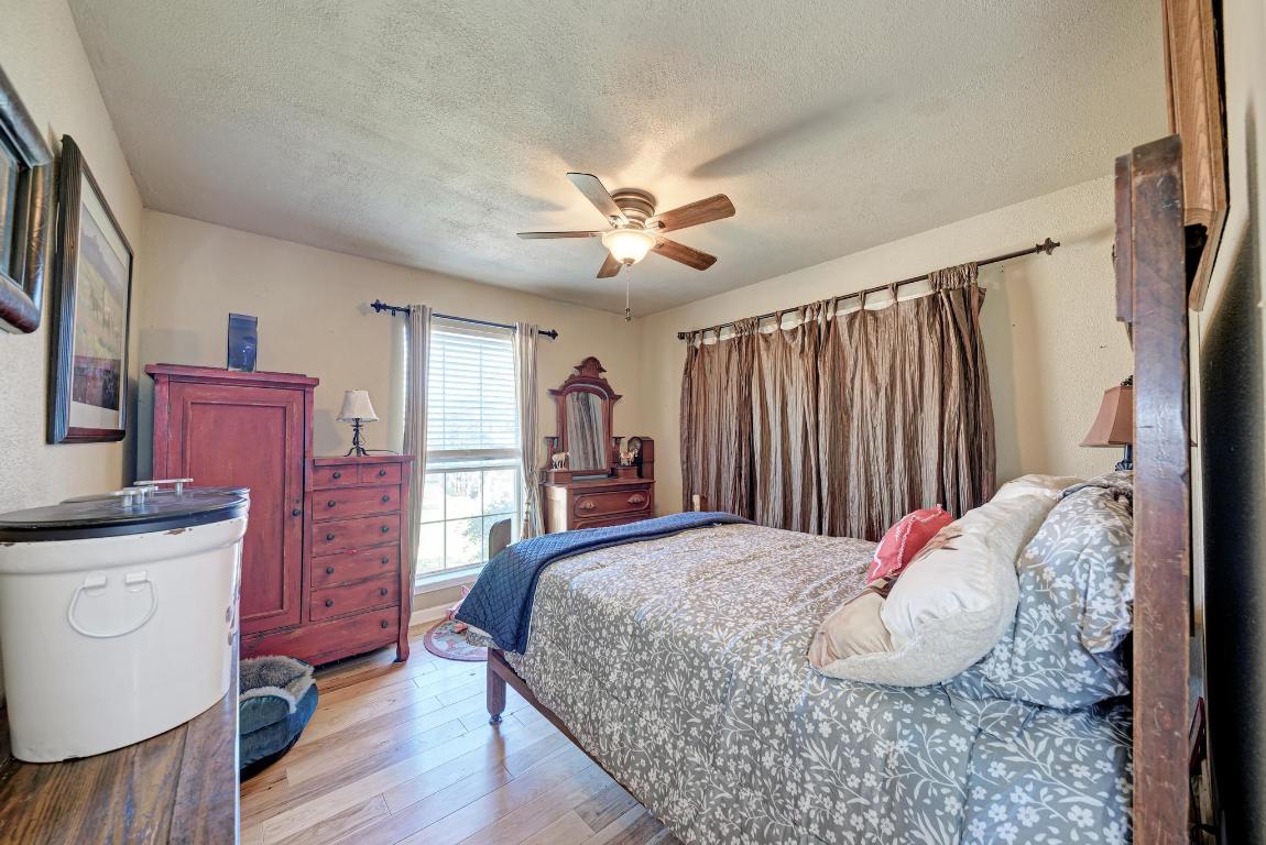 321 Navajo Trail Georgetown, TX 78633 - Photo 17 of 40 a bedroom with a bed and a chandelier