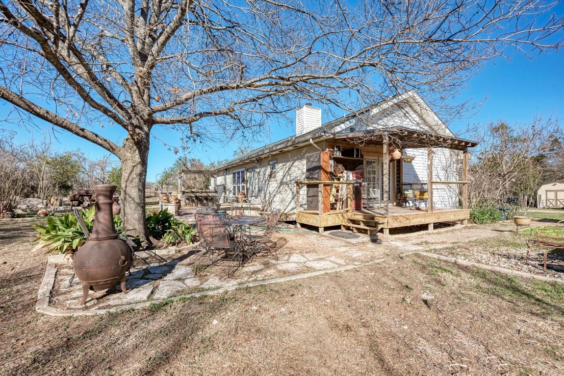 321 Navajo Trail Georgetown, TX 78633 - Photo 24 of 40 a view of a patio with a table and chairs under an umbrella