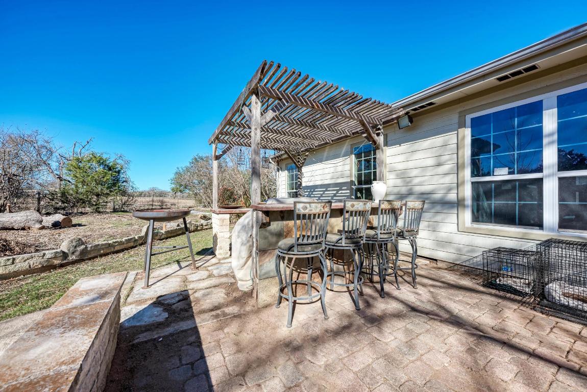 321 Navajo Trail Georgetown, TX 78633 - Photo 26 of 40 a view of a patio with table and chairs with wooden floor and fence