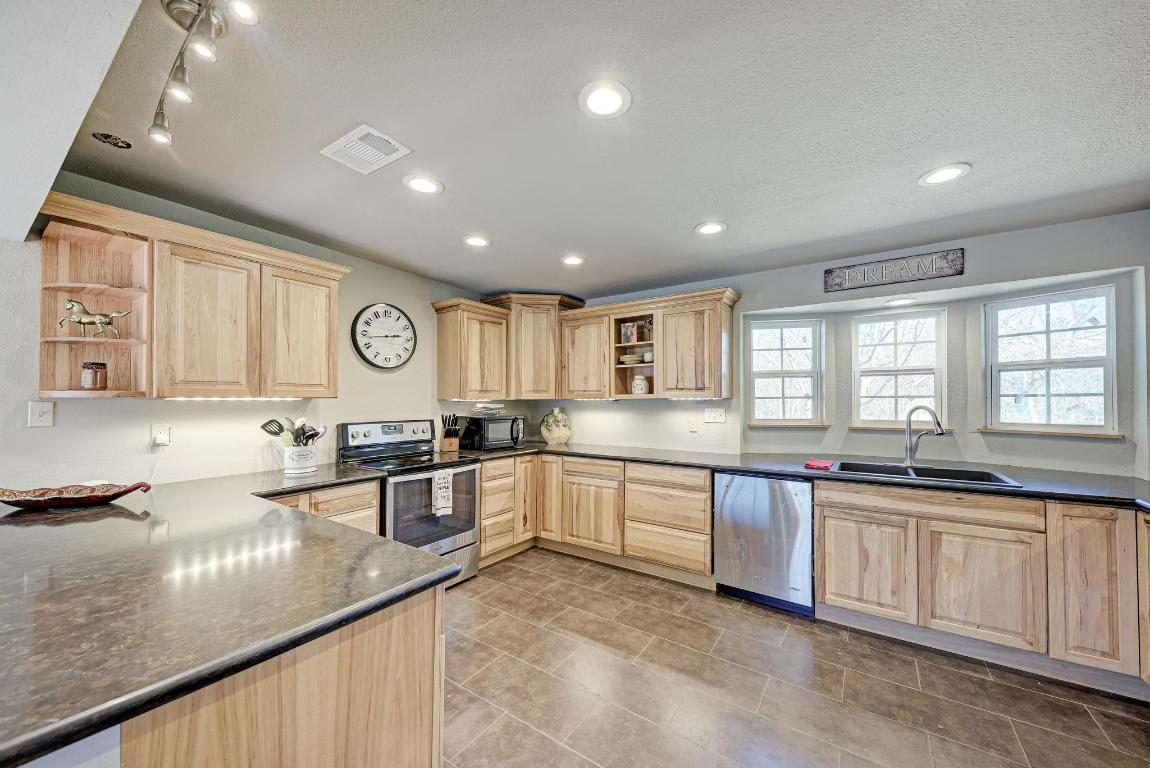 321 Navajo Trail Georgetown, TX 78633 - Photo 9 of 40 a large kitchen with lots of counter space sink and appliances