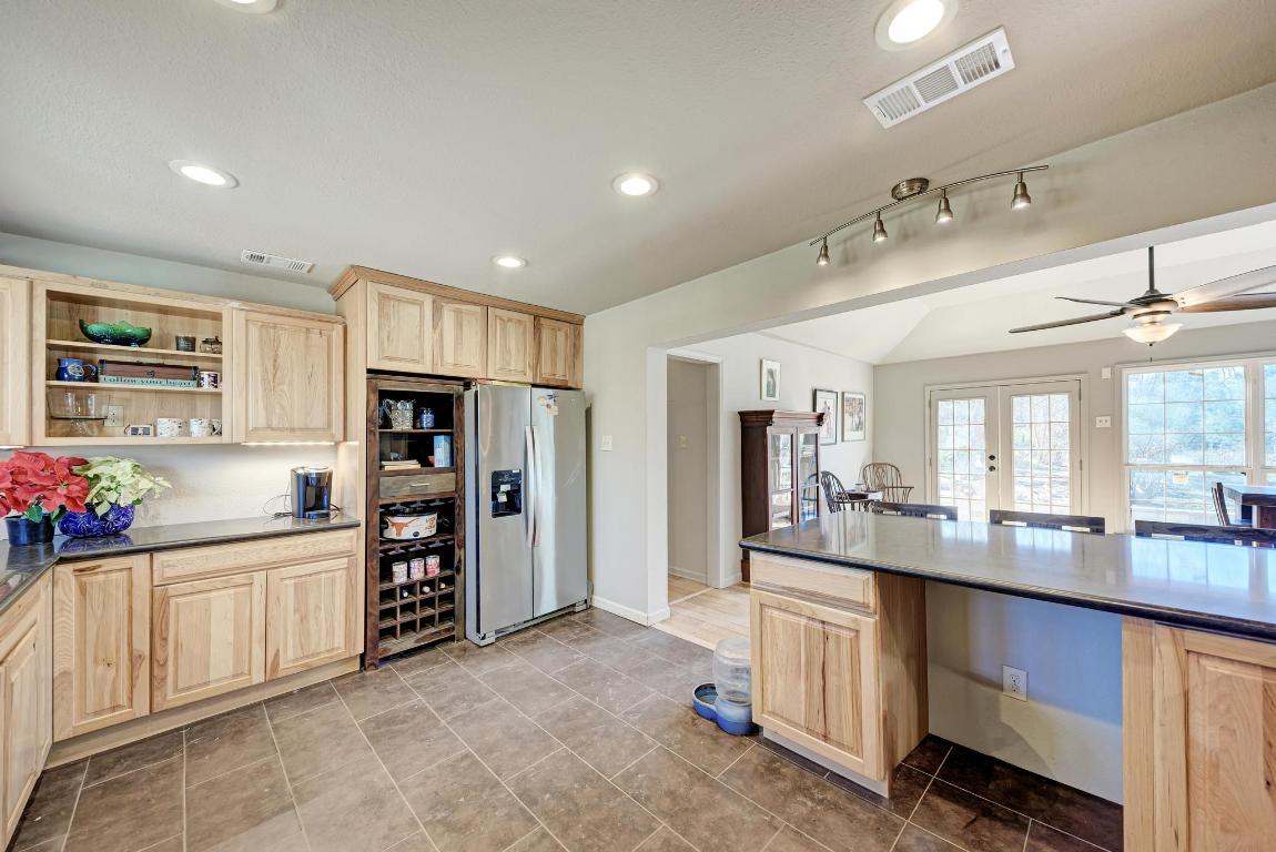 321 Navajo Trail Georgetown, TX 78633 - Photo 10 of 40 a kitchen with refrigerator and cabinets