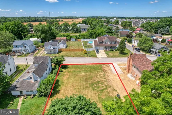 an aerial view of residential houses with outdoor space and street view