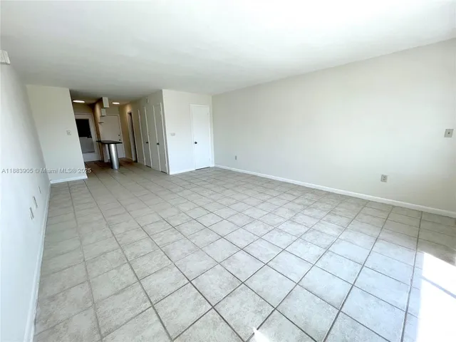 a view of a room with a dining table and chairs