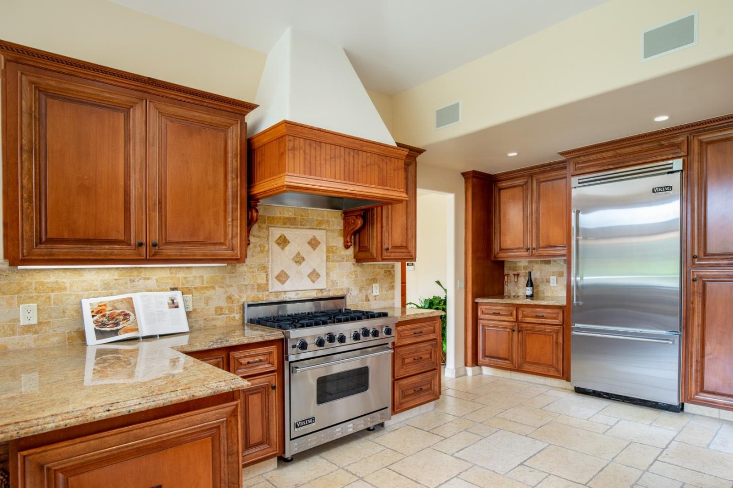 1060 Rodeo Road Pebble Beach, CA 93953 - Photo 11 of 30 a kitchen with stainless steel appliances granite countertop a stove and a refrigerator