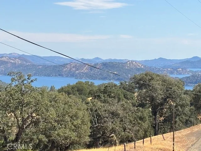 an aerial view of mountain with house in background