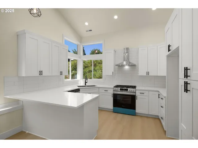 a kitchen with a sink stove and cabinets