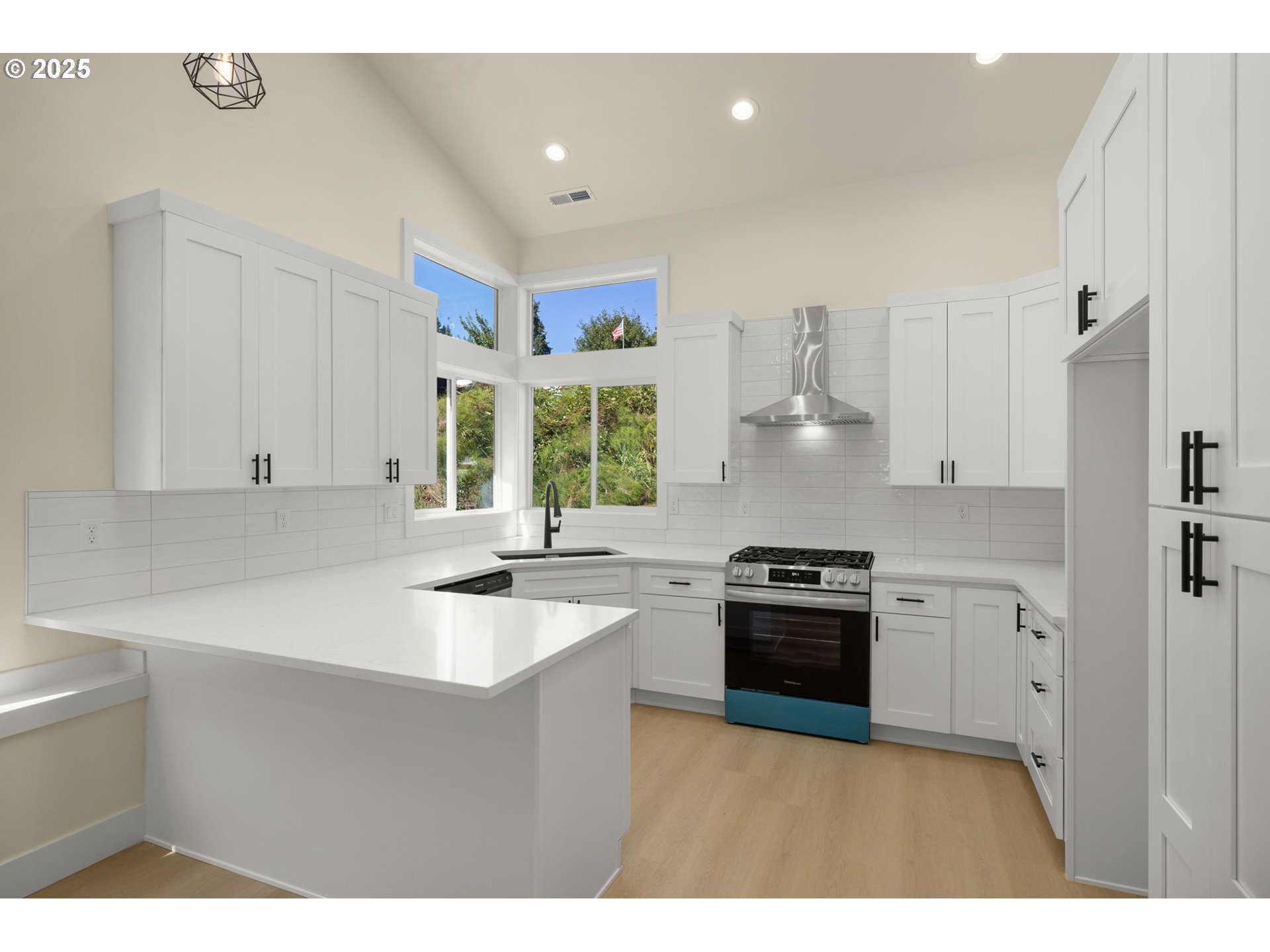 32904 Northwest View Terrace Place Scappoose, OR 97056 - Photo 13 of 34 a kitchen with a sink stove and cabinets