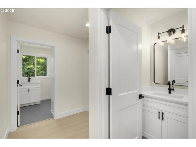 a bathroom with a double vanity sink a mirror and a shower