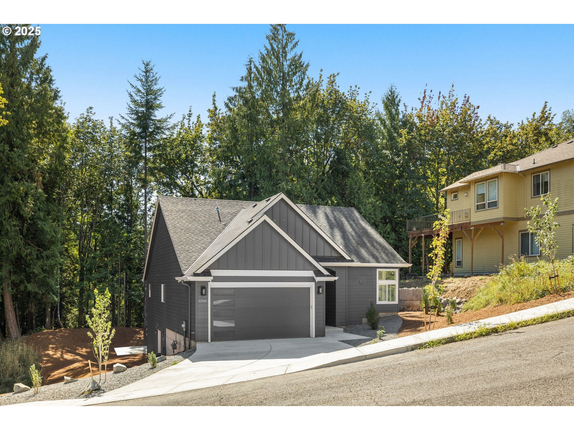 32904 Northwest View Terrace Place Scappoose, OR 97056 - Photo 3 of 34 a front view of a house with a yard