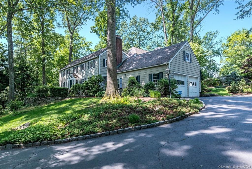 Set back from the road on a professionally landscaped 1 acre property.