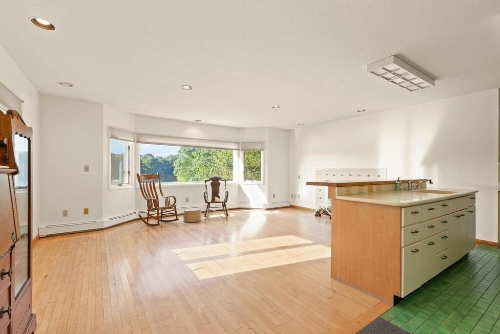 98 Dudley Road Wayland, MA 01778 - Photo 11 of 41 a view of an empty room with a window and wooden floor