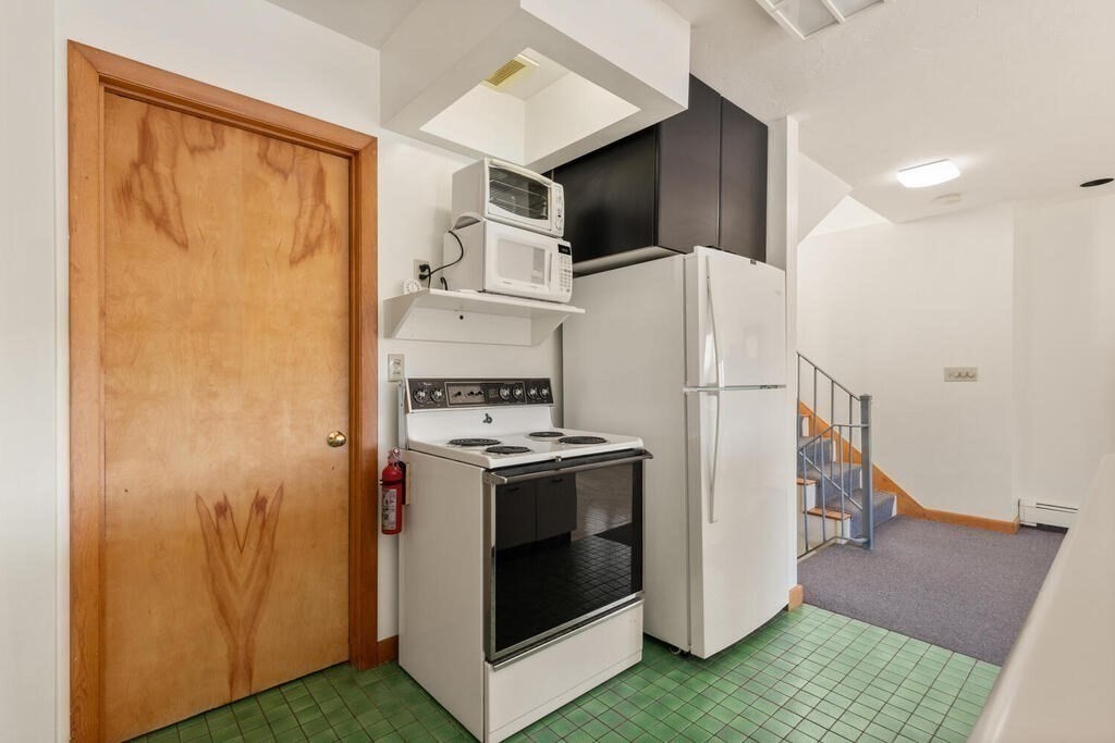 98 Dudley Road Wayland, MA 01778 - Photo 12 of 41 a kitchen with a refrigerator sink and stove