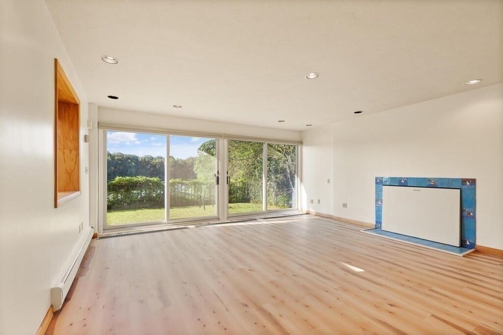 98 Dudley Road Wayland, MA 01778 - Photo 17 of 41 a view of an empty room with wooden floor and a window