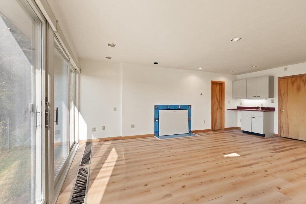 98 Dudley Road Wayland, MA 01778 - Photo 18 of 41 a view of empty room with wooden floor and window