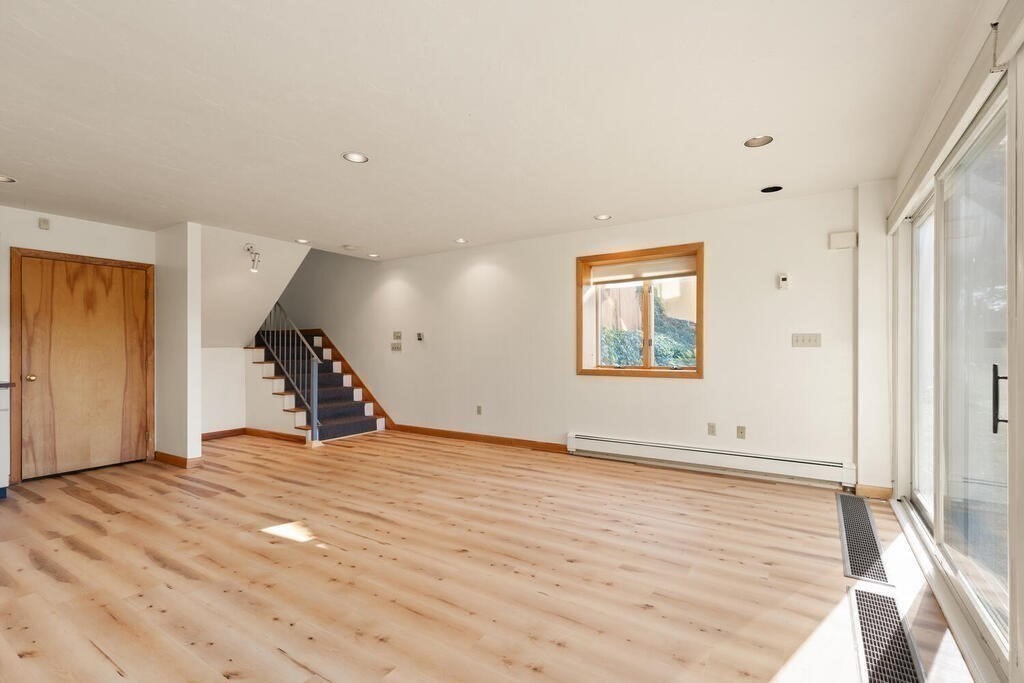 98 Dudley Road Wayland, MA 01778 - Photo 20 of 41 a view of an empty room with wooden floor and a window