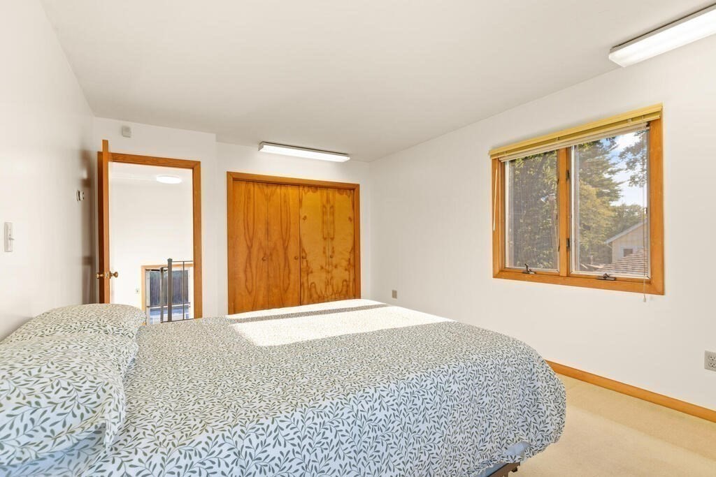 98 Dudley Road Wayland, MA 01778 - Photo 23 of 41 a bedroom with a large bed and a large window