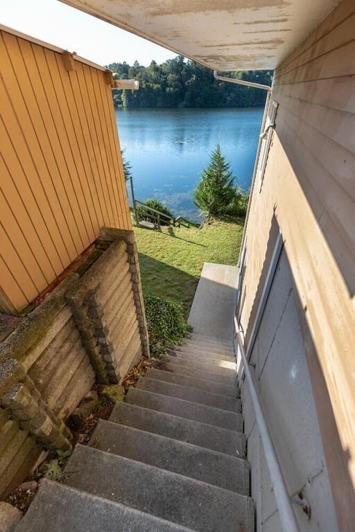 98 Dudley Road Wayland, MA 01778 - Photo 34 of 41 a view of a lake with couches and wooden floor