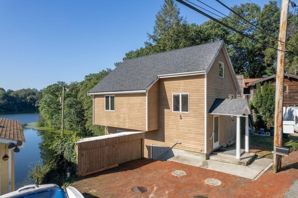 98 Dudley Road Wayland, MA 01778 - Photo 4 of 41 a backyard of a house with plants and outdoor seating