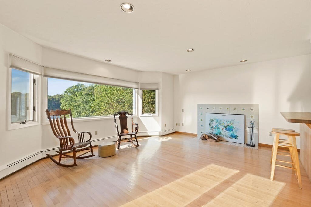 98 Dudley Road Wayland, MA 01778 - Photo 7 of 41 a view of a livingroom with furniture a fireplace and a large window