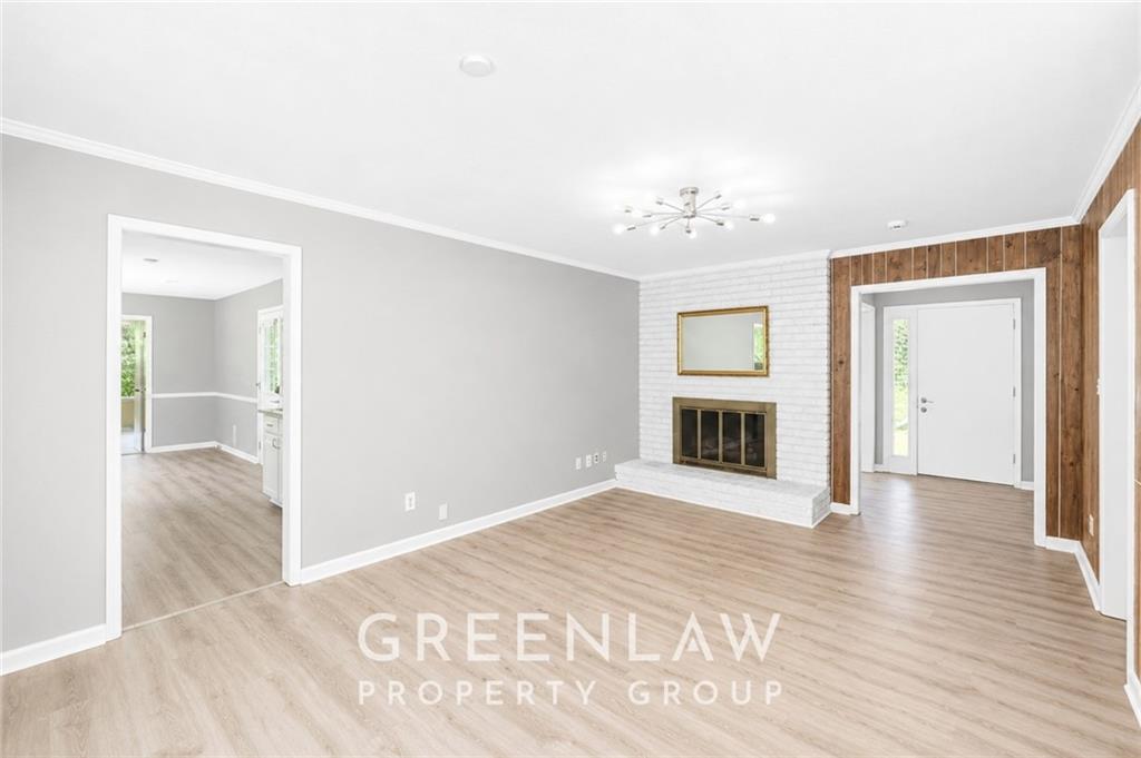 3605 Flat Shoals Road Atlanta, GA 30349 - Photo 11 of 35 a view of an empty room with wooden floor and a window