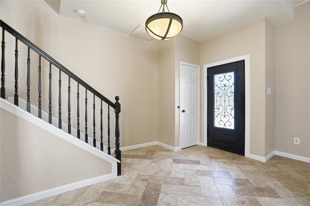 2133 Rustic Ridge Drive Keller, TX 76248 - Photo 3 of 40 Foyer with stairway and light stone finish floors