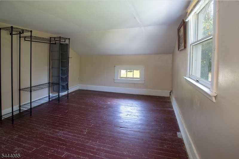 79 Lake Wallkill Road Vernon, NJ 07461 - Photo 20 of 27 an empty room with wooden floor and windows