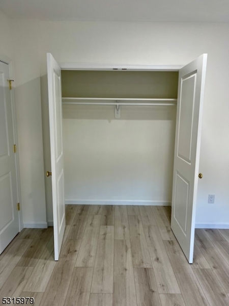 1283 Springfield Avenue, Unit B New Providence, NJ 07974 - Photo 8 of 15 a view of an empty room with wooden floor