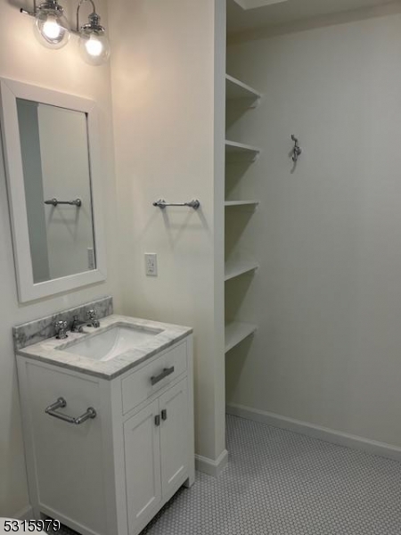 1283 Springfield Avenue, Unit B New Providence, NJ 07974 - Photo 9 of 15 a bathroom with a granite countertop sink and a mirror