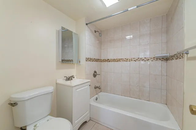 a bathroom with a toilet a sink and bathtub