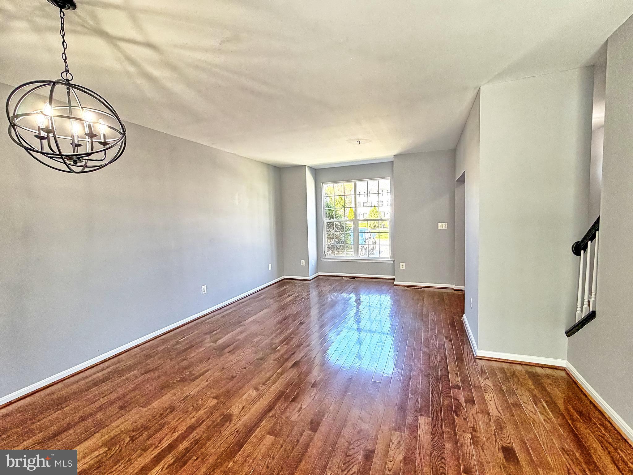 1816 Graymount Way Edgewood, MD 21040 - Photo 3 of 23 a view of an empty room with wooden floor and a window