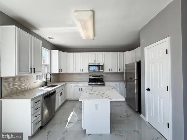 a kitchen with a sink stove and refrigerator